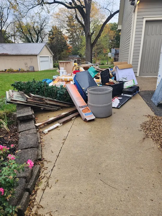 Dumpster being loaded with debris for Estate Cleanout Dumpster Rental in Lacombe